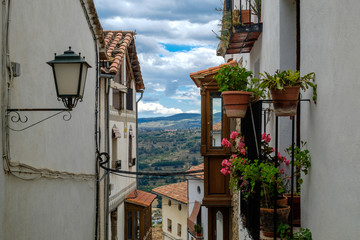 Fototapeta na wymiar Nice little balcony and the walls of Morella houses, Spain.