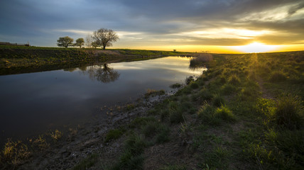 beautiful sunset at the river in the village