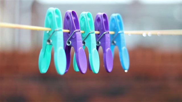 Clothes pegs on washing line on a wet rainy day 
