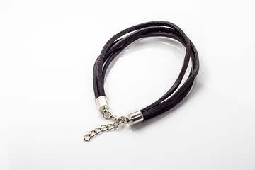 Bracelet made with black leather straps isolated on white background