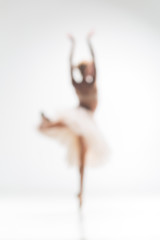 Blurred silhouette of ballerina on white background © master1305