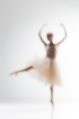 Blurred silhouette of ballerina on white background © master1305