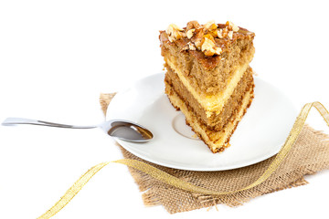 Piece of cake on a saucer with a spoon