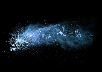 Fototapeta premium Explosion of blue powder on black background