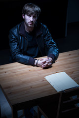 Young criminal sitting