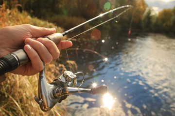 Autumn fishing spinning in his hand