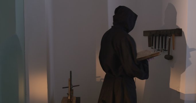 Monk, Man With Beard And Mustache in Black Clothes, Black Hood, Holding a Book, Nestor the Chronicler's Book "The Tale of Bygone Years"