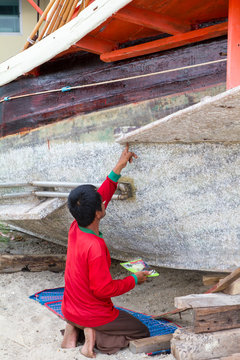 Fisherman repairing his boat