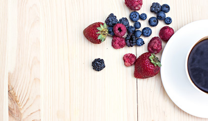 Summer berries (strawberries, raspberries, blueberries, blackberries) and a cup of coffee 