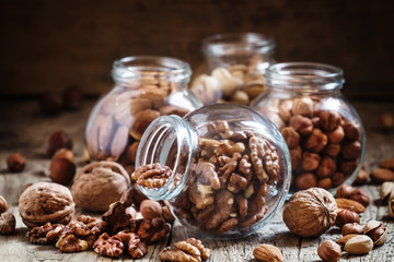 Walnuts in a glass jar, nut mix, toned image, selective focus