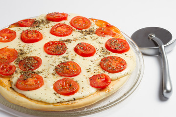 Margarita pizza and pizza knife on the white background