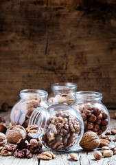 Walnuts in a glass jar, nut mix, toned image, selective focus