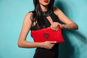 Fashionable woman with a red bag and black evening dress