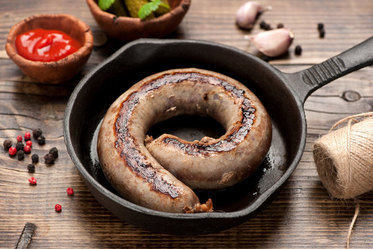 Fried sausage in a frying pan
