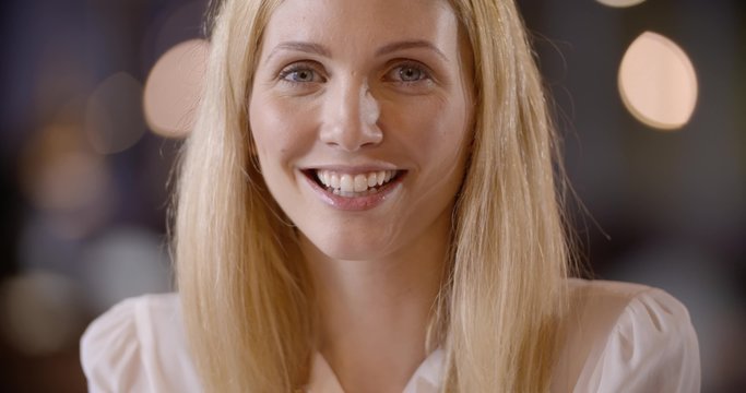 Young blonde smiling businesswoman in office portrait in slow motion (in realtime at 60 fps)