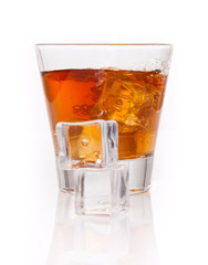 whiskey splash with ice cubes isolated on white