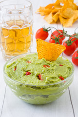 Nachos and guacamole on wood
