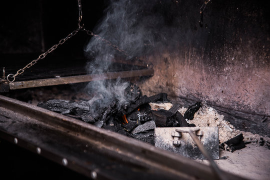 Argentinian grill, coals of fire, smoke and fire