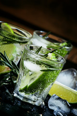 Lime Lemonade with rosemary and ice, dark toned image, selective
