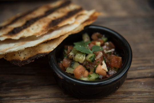 Appetizers in small bowls are on the table, and next is the bread or pita bread