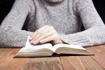 Closeup woman hand  holding pocket book to read