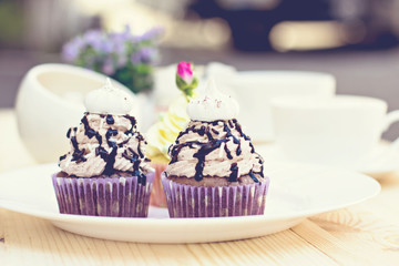 Chocolate Cupcake with chocolate frosting on the table