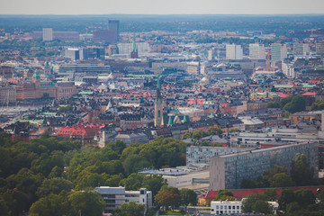 Beautiful super wide-angle panoramic aerial view of Stockholm, Sweden with harbor and skyline with scenery beyond the city, seen from the observation tower, sunny summer day with blue sky
