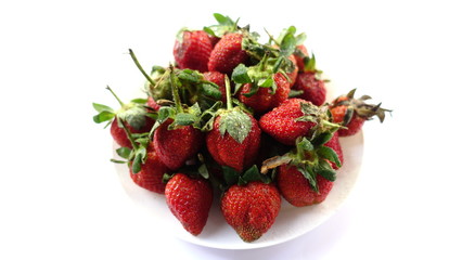 The strawberries on plate white background.