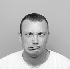 Portrait of girl with funny face against blue background