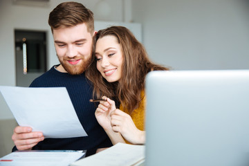 Couple managing their bills at home