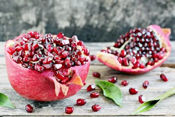 Foto auf Glas Fresh pomegranate on a rustic wooden table. Seasonal antioxidants. Selective focus  © losangela