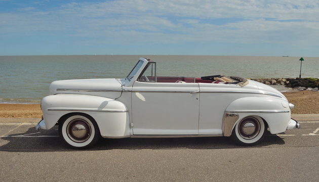 Classic Super Delux motorcar in show on seafront.