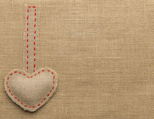 Heart Shape Sackcloth Sewing Object. Mended Burlap Background