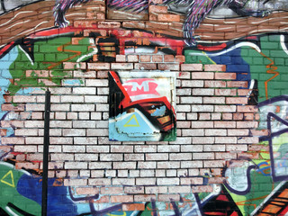Colorful brick wall with scraps of paint and graffiti - landscape photo