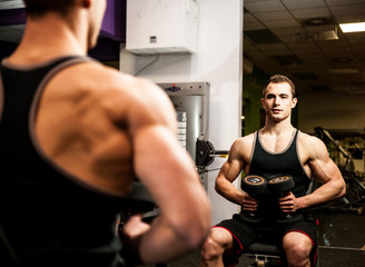 Fototapeta na wymiar Handsom young man workout in fitness gym