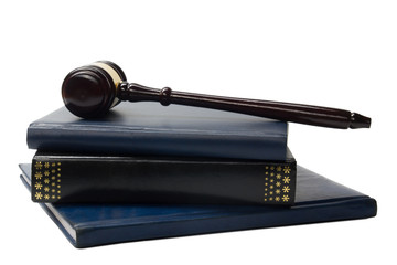 Law book with a wooden judges gavel on table in courtroom 