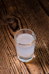 Ouzo on wooden background