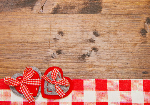 Valentines day background with handmade toy hearts over wooden t