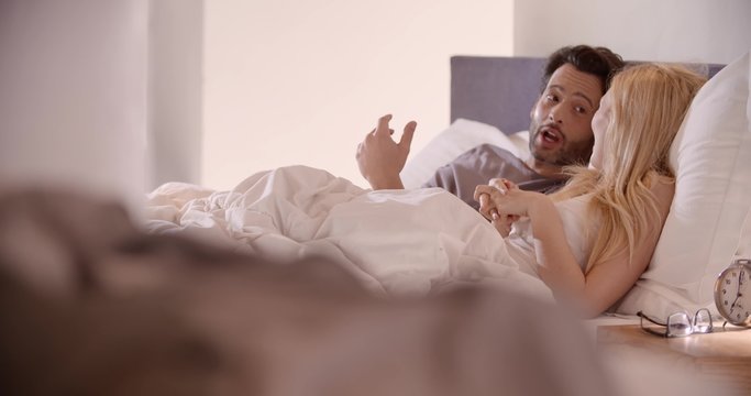 Beautiful couple chat in the morning in bed in slow motion