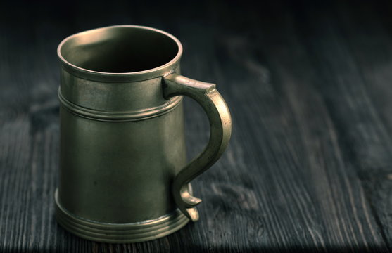 Old Pewter Mug On A Wooden Table