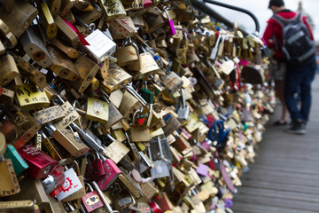 Padlocks known as love locks adorn the Pont des Arts bridge that spans the Seine River in Paris, France