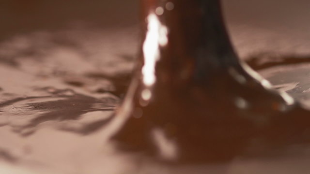Mixing delicious melted chocolate with a knife in slow motion