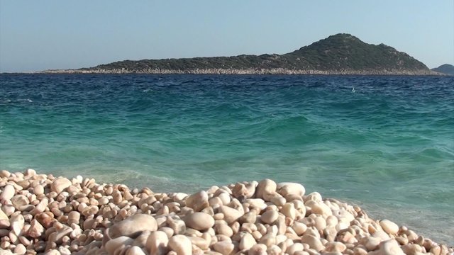 Sea is washing pebbles on the beach 