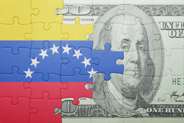 puzzle with the national flag of venezuela and dollar banknote