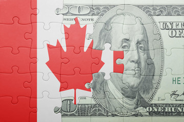 puzzle with the national flag of canada and dollar banknote