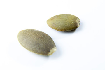 Closeup View of Pumpkin Seeds on a Plain Background