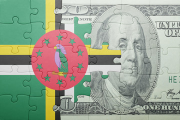 puzzle with the national flag of dominica and dollar banknote