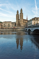 Fototapeta na wymiar Church of Grossmunster and reflection in Limmat River, Zurich, Switzerland