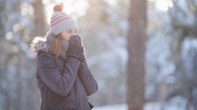 Young girl walking in the winter woods