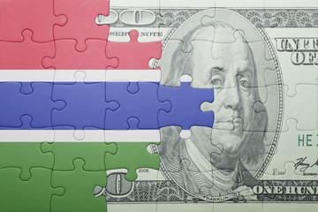 puzzle with the national flag of gambia and dollar banknote
